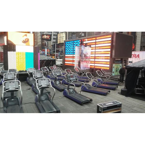 A row of new treadmills in front of an American flag.