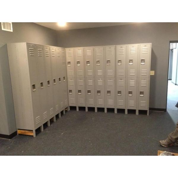 A group of new lockers in an empty room.