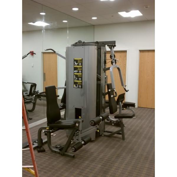 A New or Remanufactured gym machine in a room.