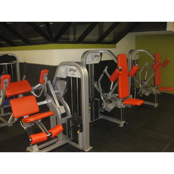 A group of exercise equipment including both new and remanufactured gym equipment in a gym.