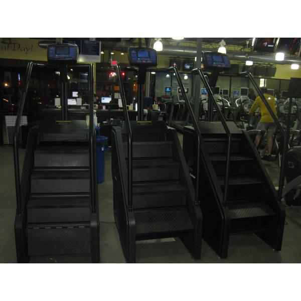 A group of **Remanufactured** treadmills in a gym.