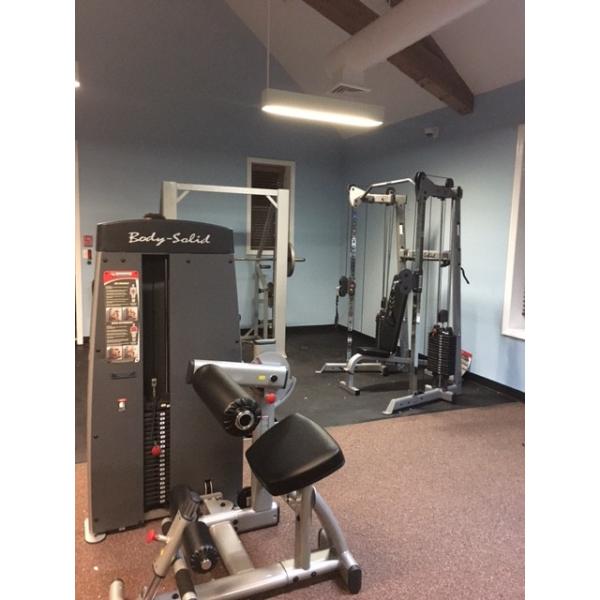 A gym room with a variety of new and remanufactured gym equipment.