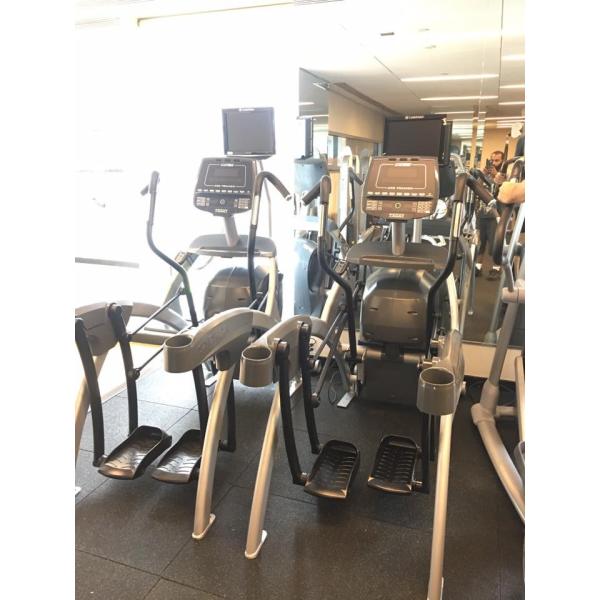 New and remanufactured elliptical machines in a gym with mirrors.