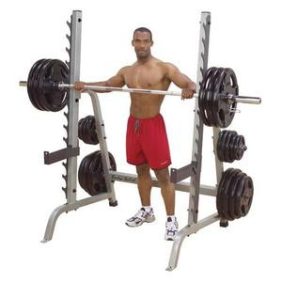 A man standing in front of a new Body Solid Plate Loaded Multi-Press Rack - New.