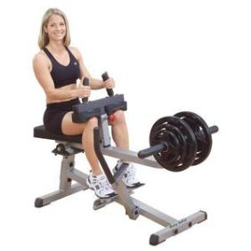 A woman is sitting on a Body Solid Plate Loaded Seated Calf Raise Machine - New.