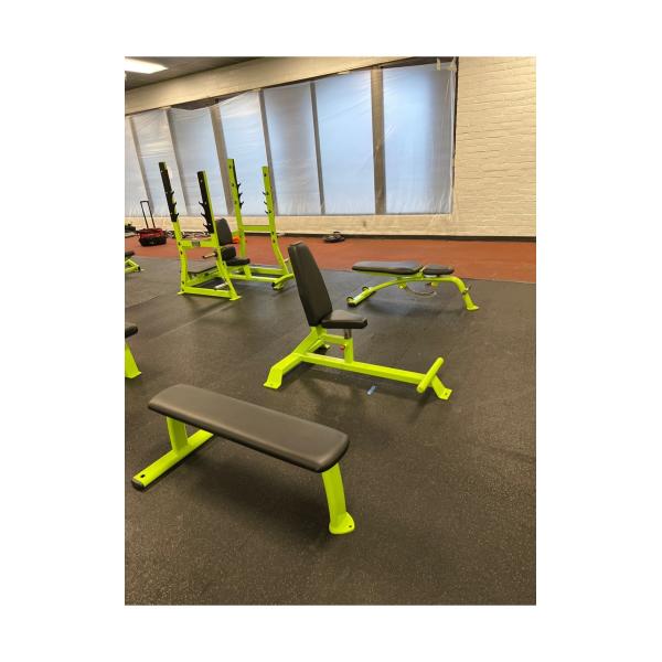 A gym furnished with new and remanufactured benches and weights.