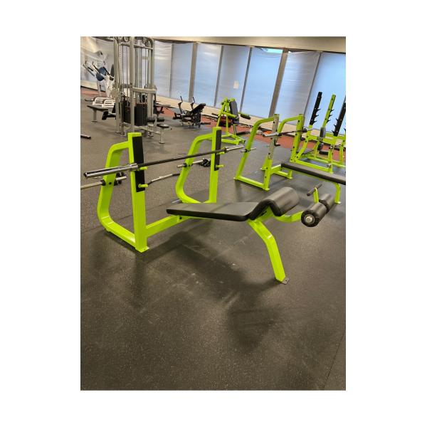 A gym with new and remanufactured benches and weights on the floor.