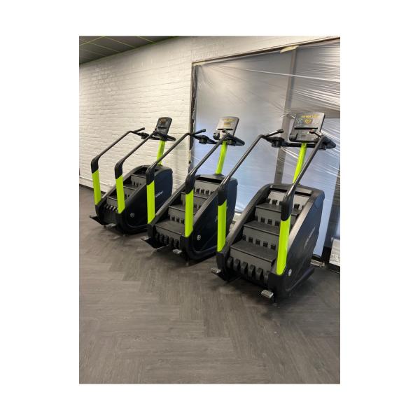 A row of new and remanufactured tread machines in a gym.