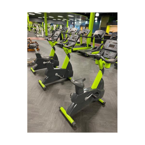 A gym with several exercise bikes, including both new and remanufactured gym equipment.