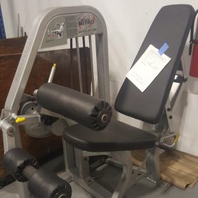 New Nautilus Nitro Seated Leg Curl (Cleaned & Serviced) with a pair of dumbbells on it.