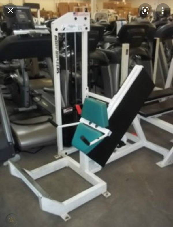 A gym with a lot of new and Body Masters 45 Degree Calf - Remanufactured equipment in it.