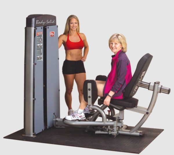 Two women standing next to a newly remanufactured Body Solid DIOT-SF Pro Dual Inner/Outer Thigh Machine.