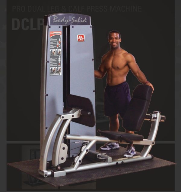 A man is standing in front of a new Body Solid DCLP-SF Pro Dual Leg/Calf Press Machine.