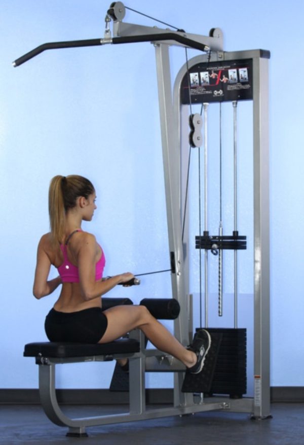 A woman is sitting on a Muscle D Fitness Lat/Low Row COMBO MACHINE in a gym.