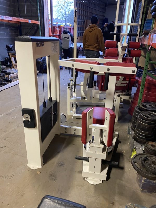 A group of Trotter Galileo Rotary Torso - As Is Functional gym equipment in a warehouse.