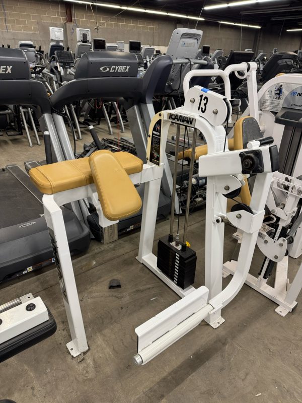 In a gym, a yellow and white weight machine labeled "Nautilus" with the number "13" stands among treadmills. Nearby, an Icarian Glute Isolator offers targeted workouts for $995.