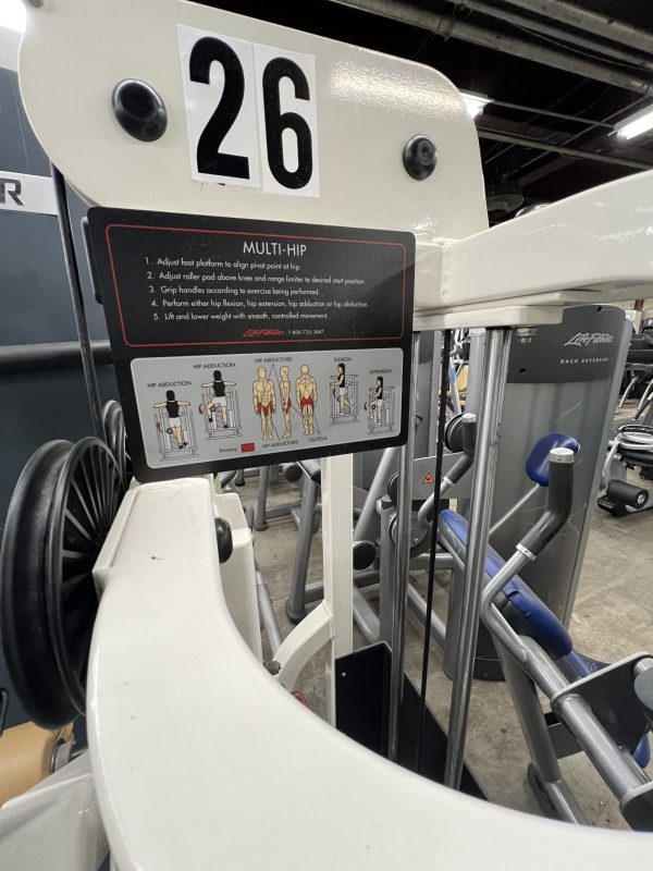 A remanufactured Precor Stretch Machine, featuring diagrams and text for easy use. It includes adjustable parts and is conveniently located on the gym floor, labeled "26," reflecting its versatile design and functionality.