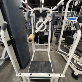 The remanufactured Precor Stretch Machine, featuring diverse handles and steps for functional training, stands on a gray concrete floor, showcasing its versatility.