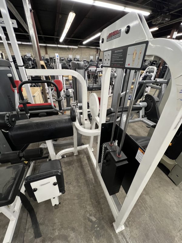 A remanufactured leg press machine with weights, outfitted in white and black, is surrounded by other exercise equipment in the gym, including a Precor Stretch Machine - Remanufactured.