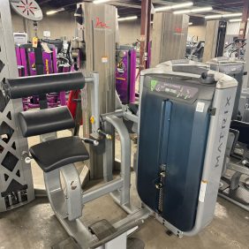 The Life Fitness Signature Ab Crunch, black model priced at $1995, offers adjustable settings and weights for a comprehensive back extension workout in fitness centers.