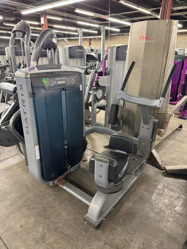 The Life Fitness Signature Ab Crunch in black, priced at $1995, features a seat with arm supports for upper body workouts and ab crunch exercises. It complements other Life Fitness machines in the gym, enhancing your fitness experience.