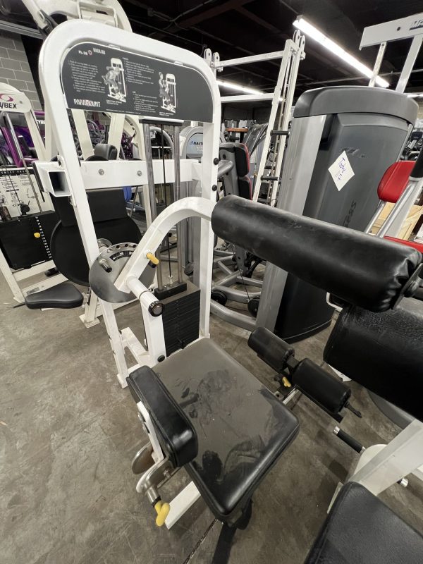 A remanufactured Precor Stretch Machine sits in a workout area with concrete flooring, surrounded by other exercise equipment, including a gym leg press machine.