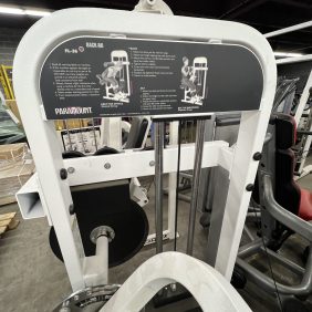 A remanufactured Precor Stretch Machine with labeled instructions on top is located in a fitness facility.