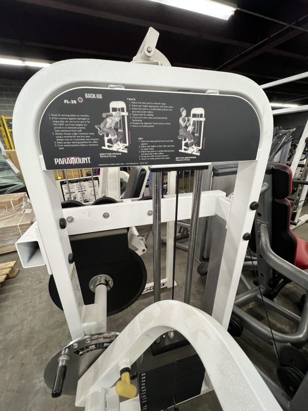 A remanufactured Precor Stretch Machine with labeled instructions on top is located in a fitness facility.